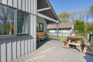 a wooden deck with a picnic table and a bench at 2 Bed in Bush oc-b31845 in Bude