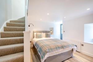 a bedroom with a bed next to a staircase at 1 Bed in Austwick oc-b31906 in Horton in Ribblesdale