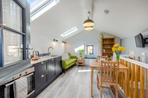 a kitchen and living room with a table and a green couch at 1 Bed in Austwick oc-b31906 in Horton in Ribblesdale
