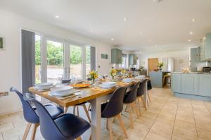 a kitchen with a long wooden table and chairs at 5 Bed in Bradworthy oc-d31987 in Bradworthy