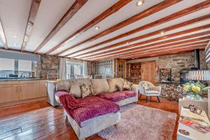 a living room with a couch and a stone wall at 2 Bed in Port Talbot oc-b30705 in Port Talbot