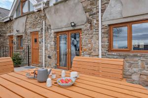 a wooden table with a bowl of fruit sitting on it at 2 Bed in Port Talbot oc-b30705 in Port Talbot