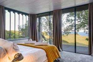a bedroom with a bed and large glass windows at 4 Bed in Ventnor oc-t32271 in Ventnor