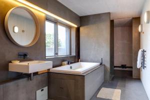 a bathroom with a tub and a sink and a mirror at 4 Bed in Ventnor oc-t32271 in Ventnor +59 photos