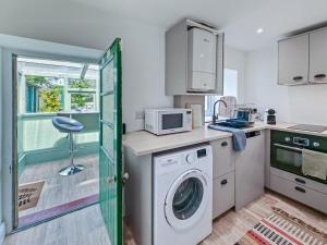 a kitchen with a washing machine and a microwave at 1 Bed in Corbridge oc-t31977 in Corbridge