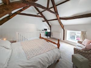 a bedroom with a white bed and a chair at 1 Bed in Corbridge oc-t31977 in Corbridge +10 photos
