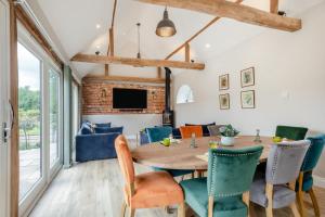a dining room with a wooden table and chairs at 2 Bed in Barton Turf oc-i29127 in Neatishead