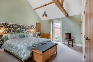 a bedroom with a king sized bed and a fireplace at 2 Bed in Barton Turf oc-i29127 in Neatishead +12 photos