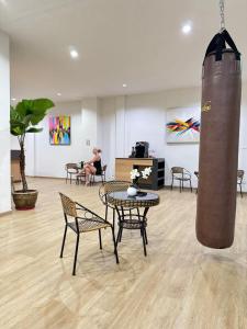 a room with tables and chairs and a woman sitting in a room at Top Residence Patong in Patong Beach