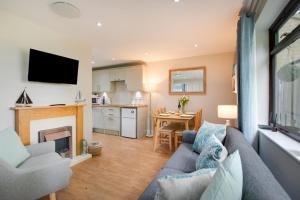 a living room with a couch and a kitchen at 2 Bed in Weybourne oc-2151 in Weybourne