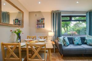 a living room with a blue couch and a table at 2 Bed in Weybourne oc-2151 in Weybourne