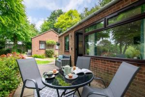 a patio with a table and chairs on a patio at 2 Bed in Weybourne oc-2151 in Weybourne +9 photos