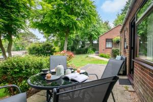 a table and chairs on the back porch of a house at 2 Bed in Weybourne oc-2151 in Weybourne