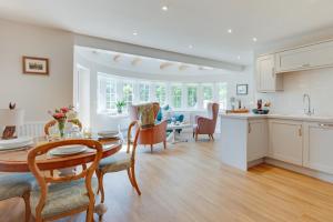 a kitchen and living room with a table and a dining room at 2 Bed in Beccles oc-rilo in Beccles
