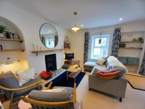 a living room with a couch and chairs and a fireplace at 2 Bed in Aberaeron oc-bow329 in Aberaeron