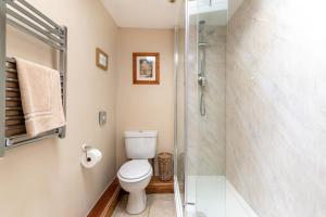 a bathroom with a toilet and a shower at 1 Bed in Swannington oc-1011 in Alderford +7 photos