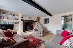 a living room with two couches and a fireplace at 4 Bed in Southwold oc-30vs in Southwold