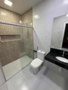 a bathroom with a shower and a toilet and a sink at Pipa House Center in Pipa