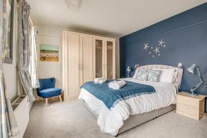 a blue bedroom with a bed and a blue wall at 2 Bed in Woodbridge oc-g23 in Woodbridge