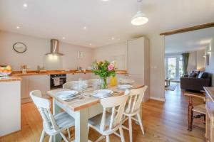 a kitchen and dining room with a table and chairs at 3 Bed in Staplecross oc-rh1162 in Sedlescombe