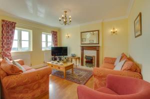 a living room with two couches and a tv at 4 Bed in Gower oc-hh9906 in Port-Eynon