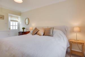 a bedroom with a large white bed with pillows at 1 Bed in Tenterden oc-tn623 in Saint Michaels