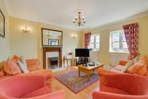 a living room with two couches and a television at 4 Bed in Port Eynon oc-hh9905 in Port-Eynon