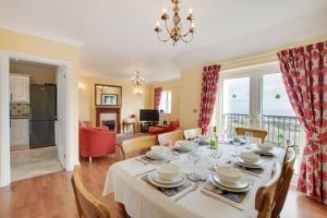 a dining room and living room with a table and chairs at 4 Bed in Port Eynon oc-hh9905 in Port-Eynon