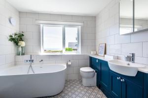 a bathroom with a tub and a sink and a toilet at 3 Bed in Greatstone oc-ek777 in Littlestone-on-Sea