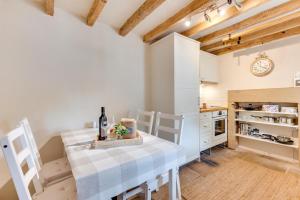 a kitchen with white cabinets and a table and chairs at 2 Bed in Middleton-by-Youlgrave oc-dchol7 in Middleton