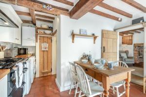 a kitchen with a wooden table and a table and chairs at 2 Bed in East Runton oc-2034 in West Runton