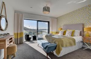 a bedroom with a large bed and a large window at 3 Bed in Woolacombe oc-5byron in Woolacombe +16 photos