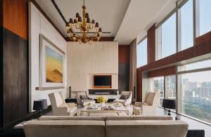 a living room with a couch and chairs and a television at The Langham, Shanghai, Xintiandi in Shanghai +133 photos