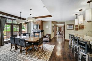 a kitchen and dining room with a table and chairs at One Ski Hill Place, a RockResort, by Vail Resorts in Breckenridge