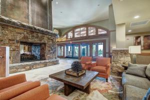 a large living room with a stone fireplace at One Ski Hill Place, a RockResort, by Vail Resorts in Breckenridge