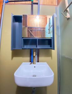 a white sink in a bathroom with a mirror at Nui Tuong Village Stay in Tân Phú +33 photos