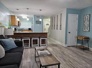 a living room with a couch and a kitchen at Seaside Gem in Biloxi
