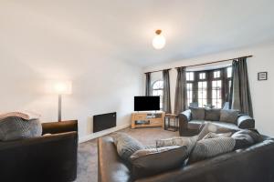 a living room with two couches and a tv at 2 Bed in Seahouses oc-nb1974 in North Sunderland