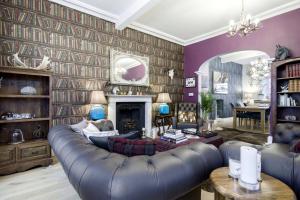 a living room with a couch and a fireplace at The Town House at Brecon in Brecon