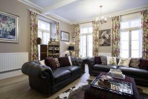 a living room with two couches and a table at The Town House at Brecon in Brecon