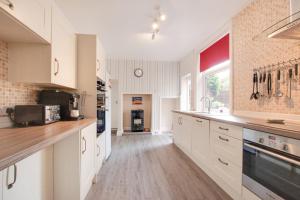 a kitchen with white cabinets and a counter top at 5 Bed in Runswick oc-wa326 in Runswick