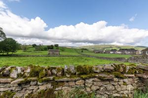 a stone wall in front of a green field at 4 Bed in Gayle oc-ds950 in Hawes