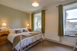 a bedroom with a bed and a large window at 4 Bed in Gayle oc-ds950 in Hawes