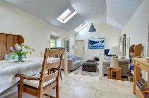 a kitchen and living room with a table and chairs at 2 Bed in Menai Bridge oc-fl046 in Llandegfan +17 photos