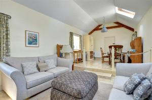 a living room with a couch and a table at 2 Bed in Menai Bridge oc-fl046 in Llandegfan