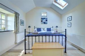 a bedroom with a bed and a skylight at 2 Bed in Menai Bridge oc-fl046 in Llandegfan
