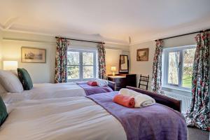 a bedroom with two beds and two windows at 6 Bed in Wymondham oc-t30598 in Wymondham