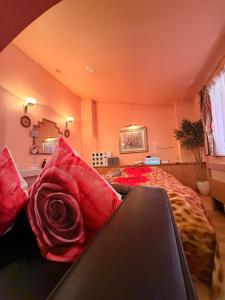 a bedroom with a bed with red pillows at ホテルプチハウス大人専用 in Barajima