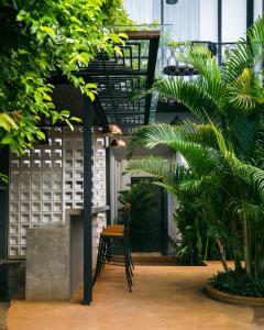 a room with a chair and some plants at Villa Sun - Boutique Hotel in Siem Reap