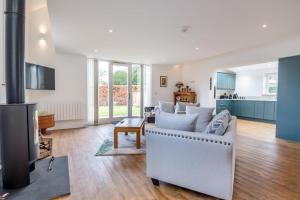 a living room with a couch and a stove at 1 Bed in Tasburgh oc-t28242 in Ashwellthorpe